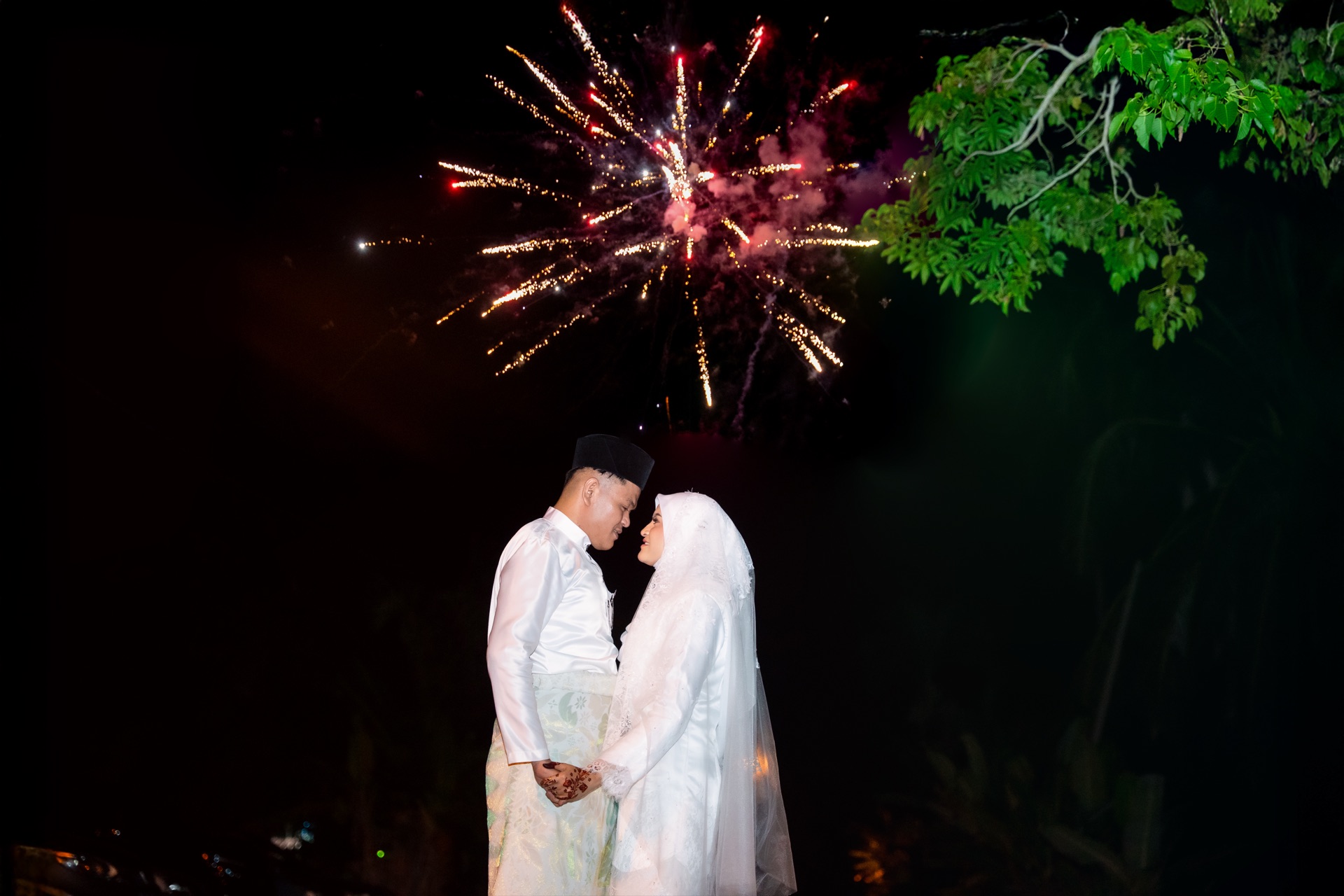 Newlyweds beneath fireworks